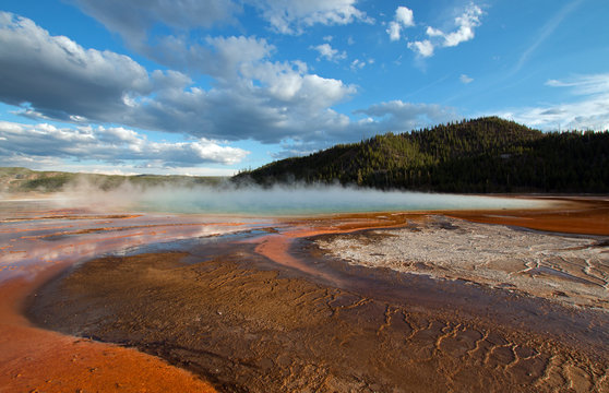 Grand Prismatic Hot Spring under sunset clouds in the Midway Geyser Basin in Yellowstone National Park in Wyoming USA