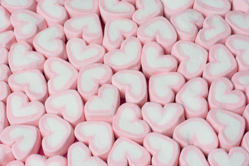 Pink heart shaped marshmallows background