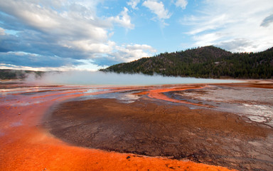 Grand Prismatic Hot Spring under sunset clouds in the Midway Geyser Basin in Yellowstone National Park in Wyoming USA