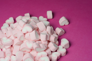 Pink heart shaped marshmallows background