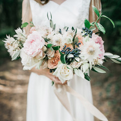 Beauty wedding bouquet in bride's hands