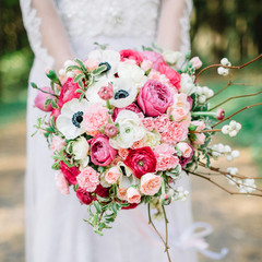 Beauty wedding bouquet in bride's hands