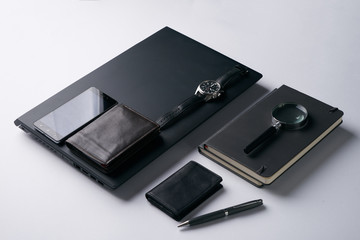 Gentleman set. Magnifying glass, mobile phone, notebook, pen, watch, purse on dark background. Copy space