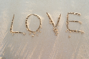 Word LOVE on a sand of beach
