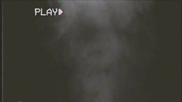 VHS retro fake shot: a smoke background, desaturated grey shapes rising like steam.

