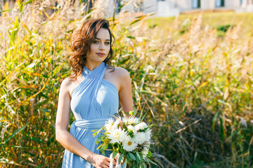Beautiful young bridesmaid with curly hair