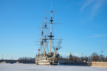 Fototapeta na wymiar Frigate Blagodat on the frozen Neva. Sunny January day. Saint Petersburg