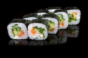 Japanese rolls on black background