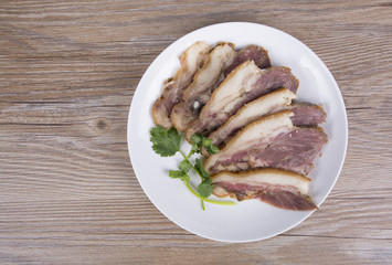 Delicious Chinese food, pig`s cheek meat,  pieces of meat cut from a pig`s head served as a cold dish to go with drinks, some marinated food in China.