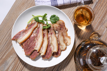 Delicious Chinese food, pig`s cheek meat,  pieces of meat cut from a pig`s head served as a cold dish to go with drinks, some marinated food in China.