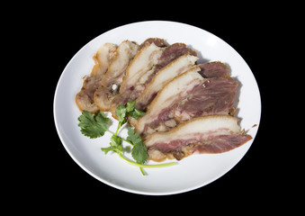 Delicious Chinese food, pig`s cheek meat,  pieces of meat cut from a pig`s head served as a cold dish to go with drinks, some marinated food in China.