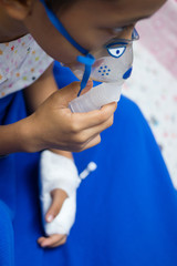 little boy with inhalator mask in hospital