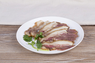 Delicious Chinese food, pig`s cheek meat,  pieces of meat cut from a pig`s head served as a cold dish to go with drinks, some marinated food in China.