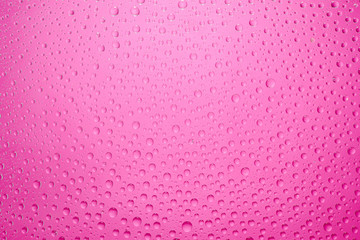 Water drops pink background. Water drops on glass background