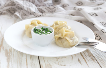Traditional Turkish manti with sour cream sauce