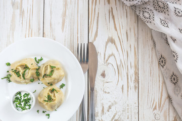Traditional Turkish manti with sour cream sauce