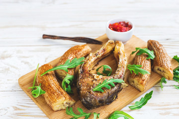 Grilled fish tilapia and chili plantains with arugula