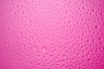 Water drops pink background. Water drops on glass background
