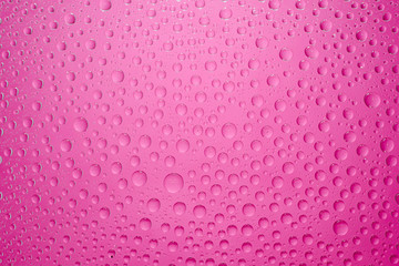 Water drops pink background. Water drops on glass background