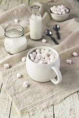 white cup with cocoa and marshmallows, selective focus