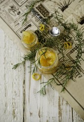 orange marmalade in small glass jars with rosemary, selective focus