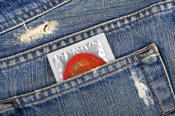 Red condom in a blue jeans pocket