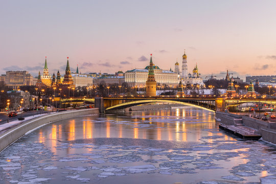 Illuminated Moscow Kremlin And Moscow River With Ice Lumps In Winter Morning. Clear Pink Colorful Sky.