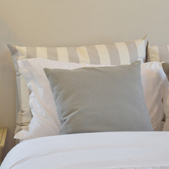 modern bedroom interior with gray and striped pillow on bed