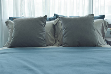 pillows setting on bed with blue color bedding style