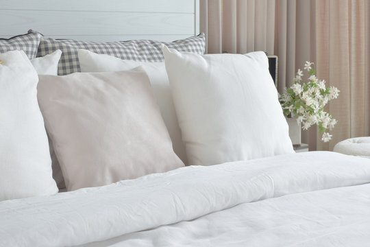 Off white pillows setting on bed with english country style bedding decoration