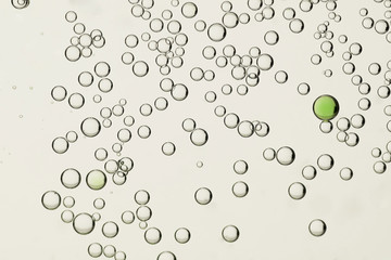 White and a green air bubbles isolated over a light background