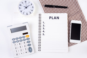 Top view of notebook  with action plan list with clock pen calcu