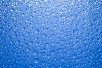 Water drops blue background. Water drops on glass background