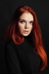 Sexy beautiful redhead girl with long hair. Perfect woman portrait on black background. Gorgeous...