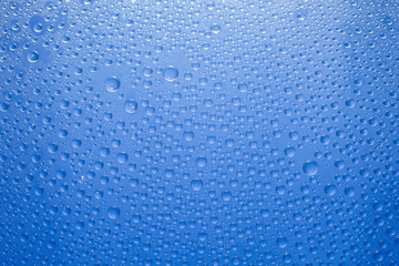 Naklejka na ściany i meble Water drops blue background. Water drops on glass background