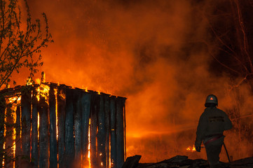 Firemen extinguish a house and building;