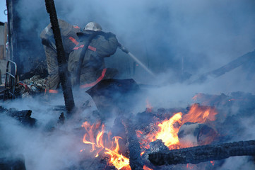 Firemen extinguish a house and building;