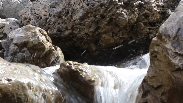 fresh flowing water rushing through the rocks of the mountain brook