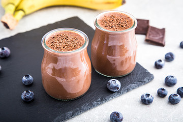 Obraz na płótnie Canvas Chocolate banana smoothie with chia seeds and blueberry 