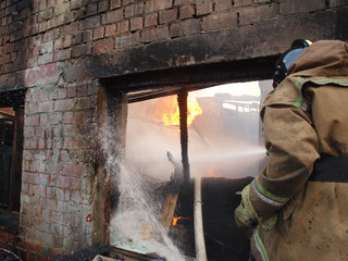 Firefighters extinguish a building