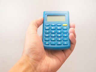 Hand holding blue calculator