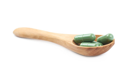 Wooden spoon filled with medical pills