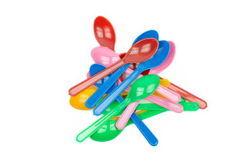 colorful plastic spoons for party isolated on white