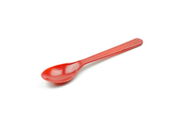 Red plastic spoon isolated on white background