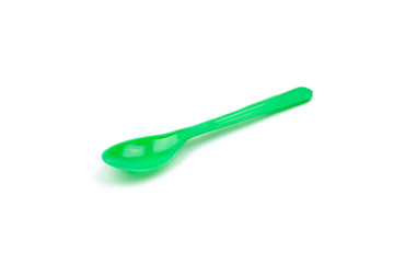 Green plastic spoon isolated on white background