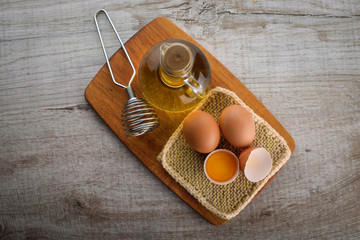 mayonnaise ingredients . oil and eggs on a beautiful tablet on wooden background