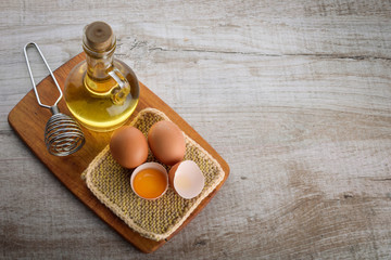 mayonnaise ingredients . oil and eggs on a beautiful tablet on wooden background