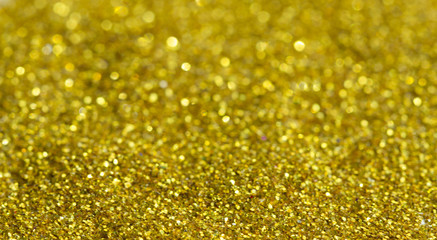Blur golden background from gold tinsels with bokeh