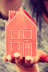 Man holding little red house, household concept