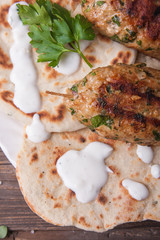 Kofta with flatbread on plate with salad